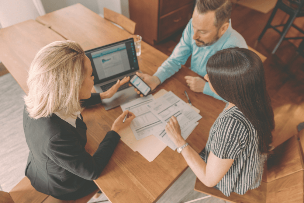 Group of three people looking at information