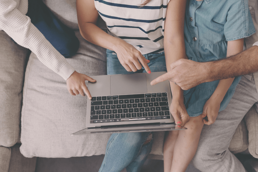 Family looking at laptop